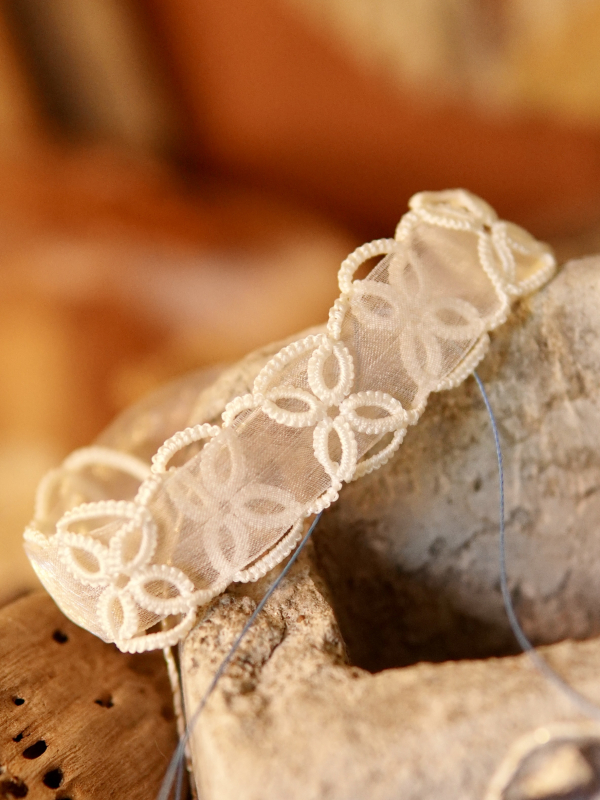 White tatted lace Petalbound bracelet with repeating petal-shaped loops