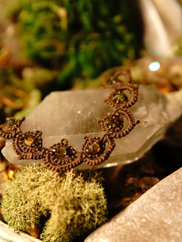 Close-up of brown lace bracelet with gold AB cube beads