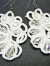 Close-up of lace earrings sparkling with clear crystals