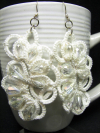 White lace earrings photographed in bright light