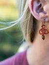 Close-up of Bloomdrop earings with orange crystal