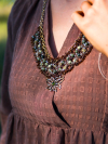 Tatted lace necklace with serpentine beads and brass focal