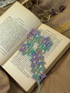 Handmade tatted lace cross bookmark in teal, green, and purple variegated thread