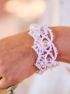 White tatted bracelet glowing with crystal facets