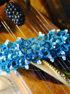 Aqua Ankars braceelt with pearls styled on wooden instrument.