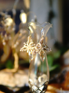 Soft gold lace earrings with crystal drops on glass vase