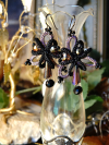 Obsidian Bloom earrings hanging from display vase