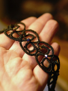 Close-up of black lace loops and crystal details