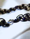 Detailed loops and beads in black tatting.