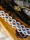Whisperbind bracelet on wooden instrument