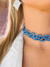 Blue tatted lace choker displayed on black velvet bust