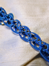 Twilight blue lace choker resting on soft fabric