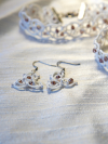 Earrings laid beside matching necklace.