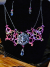 Raspberry Rain necklace and earrings displayed on a black jewelry bust