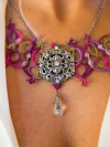 Close-up of Raspberry Rain necklace with ornate silver focal and drop
