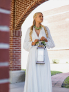 Model in white gown wearing Seralith necklace outdoors