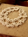 Close-up of cloudlike needle tatting with soft open ringwork.