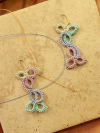 Skydrop Tangle earrings shown flat beside thread strands.