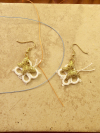 Twicewing earrings featuring brass butterflies and lace thread.