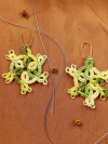 Pair of handmade lace earrings in variegated green thread inspired by woodland