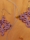 Handcrafted Lace Earrings in Lavender - Trellis Dance Lavender Trellis Dance earrings on warm flat lay background.