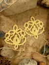 Glowing golden lace earrings evoking blooms and balance