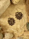 Flat-lay styling of black pineapple lace-inspired tatted earrings
