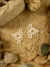 Elegant boho lace earrings photographed from above.