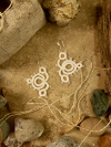Whorlwind earrings photographed to highlight fine needle-tatted details.