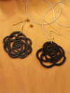 Black Sub Rosa needle tatted earrings on fabric background
