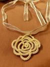 Handmade yellow lace flower pendant on translucent ribbon necklace.