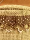 Close-up of Ribbon Reverie choker in brown with lace and bead detail.