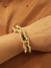 Model wearing hand-tatted jute bracelet with wooden beads