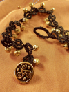 Black tatted lace anklet with golden bells and triskele clasp.