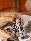 Artisan lace earrings that reflect mystery and quiet grace.
