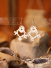 Elegant tatted earrings evoking early 20th-century design