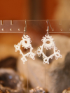 Tatted earrings featuring circular and clover-like motifs.