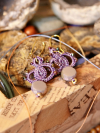 Artisan lace earrings with circular motif and bead drop.