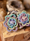 Hand-tatted floral earrings in shades of pink, lavender, aqua, and green.