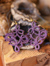 Lavender earrings with seed bead accents, tatted in a medallion shape.