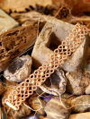 Bracelet of coral tatted lace on bohemian backdrop