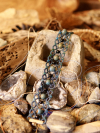 Stoneveil Tatted Lace Bracelet draped across cement and geodes