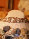 Artistic photo of the choker nestled in a rustic backdrop.