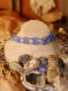 A tatted lace choker featuring repeating X-shaped motifs in blue thread.