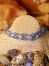 Boho-style handmade lace necklace on bust against bohemian backdrop.