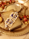 Tatted bracelet with blue porcelain beads on a silver tray