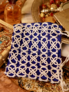 Drawstring lace bag with intricate handmade detail.