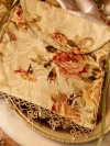 Floral fabric purse with sage green tatted lace trim.