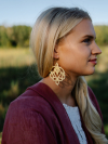 Model Wearing Lotusborne Earrings Outdoors Woman wearing Lotusborne earrings in golden evening light