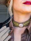 Crystal-center closeup of gold and black tatted choker